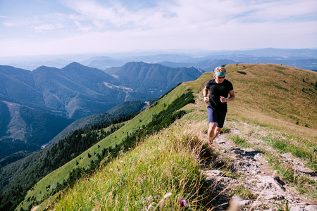 Cross country runner have a training on the mountain trackの写真素材