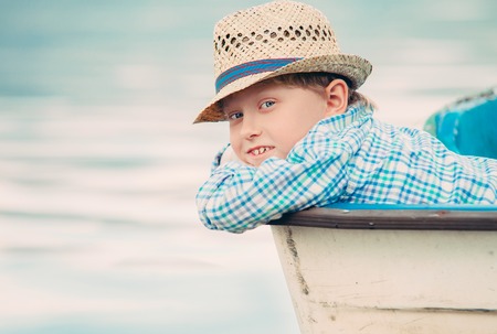 Boy in old boat portraitの写真素材