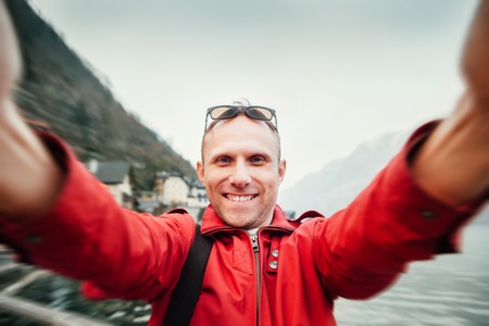 Man take his journey selfie photo with wide angle cameraの写真素材