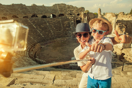 Mother with son take a vacation photo on the Side ampitheatre viewの写真素材