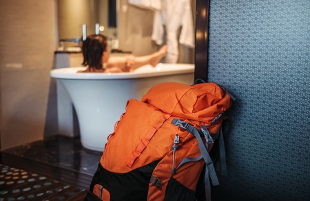Woman backpacker traveler take a bath in high quality hotel