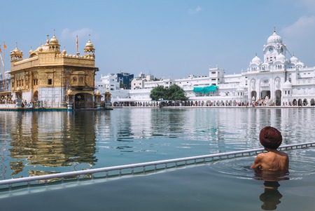 Sikh pilgrim in saint pool in Golden Temple, Amritsarの写真素材