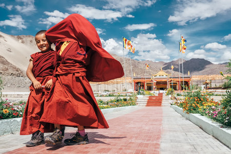 Thiksey village in Ladakh, India - AUGUST 20: Two little boys monks stepping and smiling in Thiksey Monastery on August 20, 2016 in Thiksey village in Ladakh, Indiaのeditorial素材