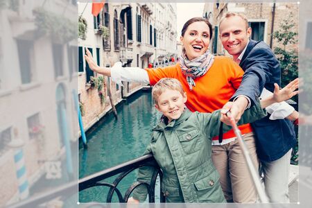 Happy family take a self photo on the one of bridges in Veniceの写真素材