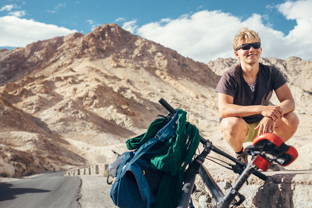 Young tourist man travel with bike in Himalaya montainの写真素材