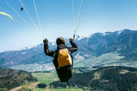 Paraglider is on the paraplane strops - soaring flight momentの写真素材