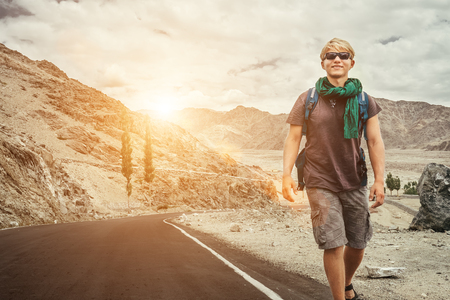Traveler walks on the mountain road in indian Himalayaの写真素材
