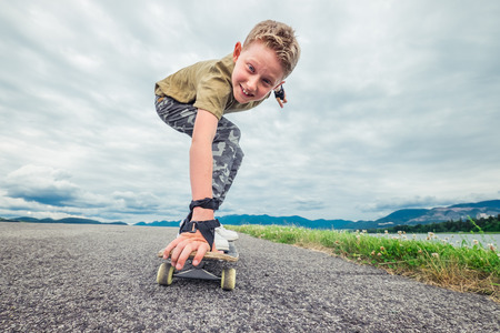 Smiling boy skates on skateboardの写真素材