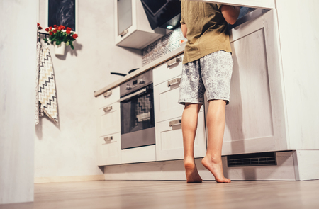 Little boy on kitchen try to find something in rifregeratorの写真素材