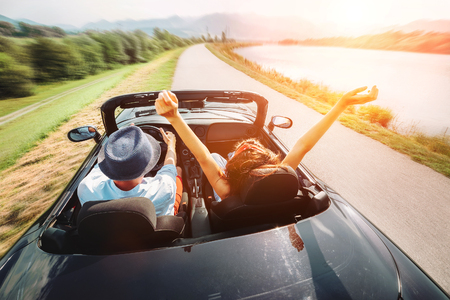 Couple in love ride in cabriolet carの写真素材