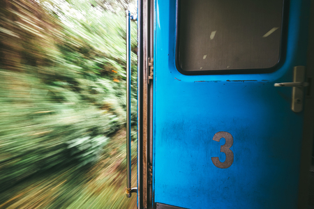 Open door in train wagon during it movingの写真素材