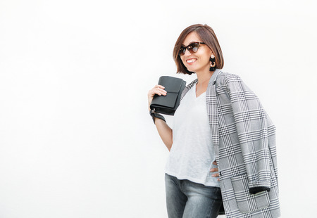 Woman in monochrome casual outfit with checkered jacketの写真素材