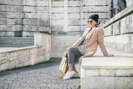Woman in casual multilayered outfit on the city streetの写真素材