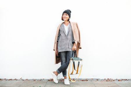 City street fashion look. Woman dressed in multilayered outfit for autumn daysの写真素材