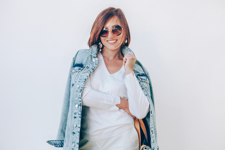 Happy elegant smiling woman in denim jacketの写真素材
