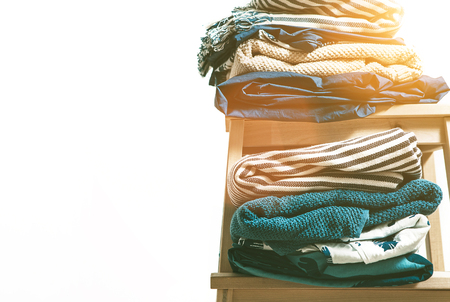 Towels, blankets and other home textile in blue and beidge colors are on the stoolの写真素材