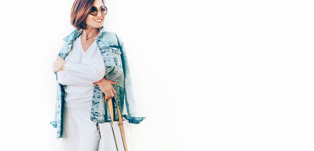 Woman in elegant outfit with oversize denim jacket. City street fashionの写真素材
