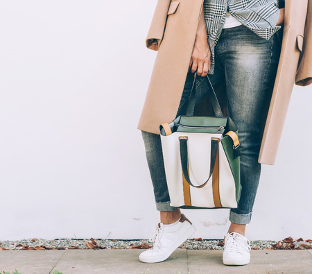 Young Woman in elegant outfit with oversize denim jacket and shopper bagの写真素材