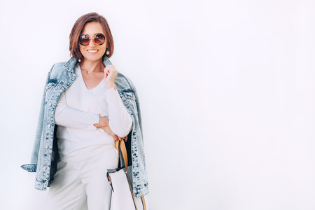 Smiling elegant woman in denim jacket portraitの写真素材