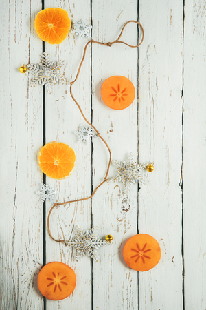 White wooden  with christmas decoration and fruits piecesの写真素材