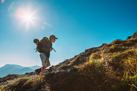 Little Boy backpacker traveler walk up on mountain topの写真素材