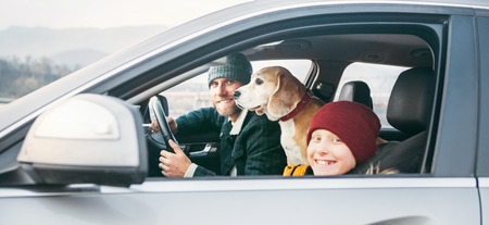Father and son Family traveling by car with beagle dog.の写真素材