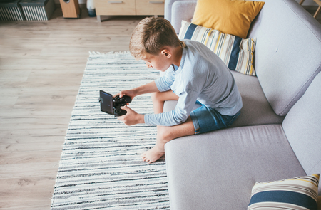 Preteen boy playing with phone game.の写真素材