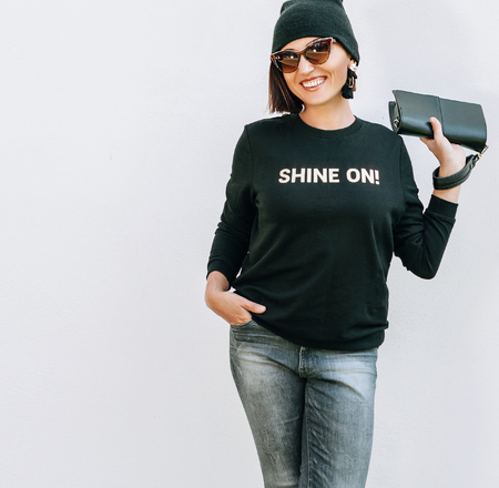 Smiling caucsaian woman in trendy casual grey black outfit for spring summer days. Sweatshirt with funny positive print.の写真素材