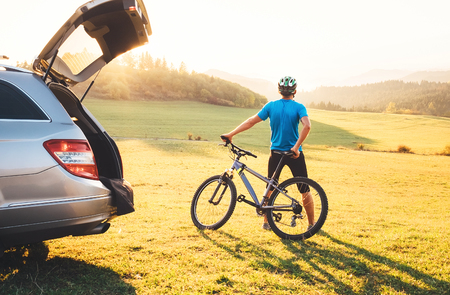 Man with bMan came by auto in mountain with his bicycle on the roof. Mountain biking concept imageの写真素材