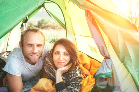 Portrait of Marriage couple meet morning in the green color tent. Smiling people concept photo.の写真素材