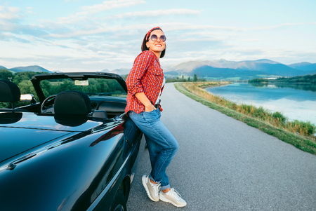 Woman in comfort casual outfit stay near Convertible carの写真素材
