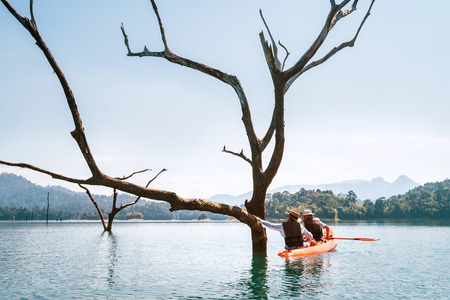 Mother and son travelers explore the Cheow Lan lake in Thailandの写真素材