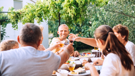 Family have dinner in summer gardenの写真素材