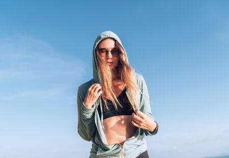 Young woman in comfort fashion sport outfit enjoing with calm morning sunの写真素材