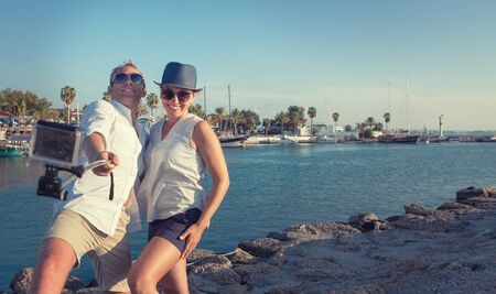 Funny couple take vacation selfie on the sea bayの写真素材