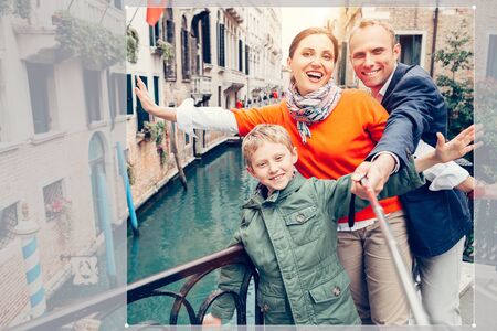 Happy family take a self photo on the one of bridges in Veniceの写真素材