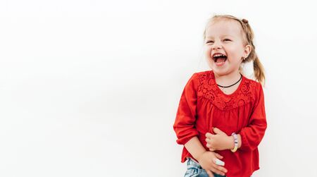 Cheerful laughing little girl in red blouse . Studio Shooting on the white background.の写真素材
