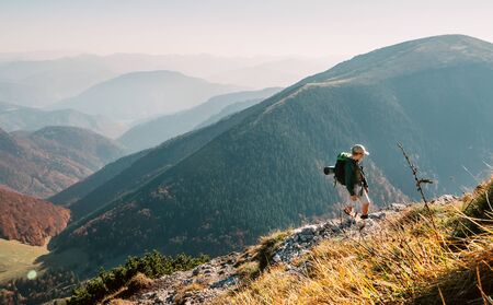 Little Boy backpacker traveler walking up on mountain top in High Tatra mountainsの写真素材