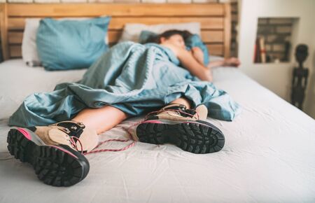 All time ready for trekking. Hiker female sleeping in comfort trekking boots.の写真素材
