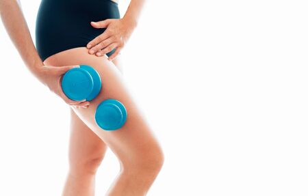 Young female making massage using a two silicone cups for vacuum Cupping anti-cellulite Massage Therapy on her thigh zone skinの写真素材