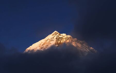 Nuptse 7861m mountain peak sunset evening Lobuche settlement view covered with snowの写真素材