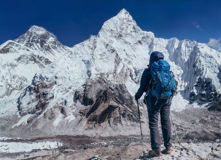 Young hiker backpacker female taking brake in hike walking enjoying Khumbu Glacier.の写真素材