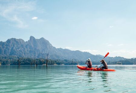 Mother and son floating on kayak together on Cheow Lan lake in Thailandの写真素材