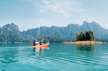 Mother and son floating on kayak together on Cheow Lan lake in Thailand	の写真素材