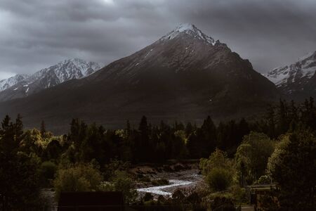 Dramatic sky with sunbeams breaking through heavy clouds over the Slavkovsky siit (peak) 2452m is the fourth highest mountain peak in the High Tatra mountains in Slovakia.の写真素材