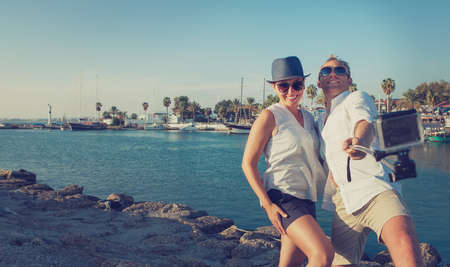 Funny couple take vacation selfie on the sea bayの写真素材