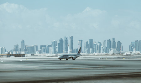 Doha, Qatar - January 2, 2018: Qatar Airways aircraft with downtown skyscrapers on the background...