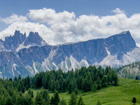 Picturesque Dolomite Alps formation Landscape photo with green spruces hill near Cinque Torri in South Tyrol, Italy. Beauty in Nature and mountain concept image.の写真素材