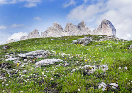 Landscape photo of the green hill with picturesque Dolomite Alps view near Tre Cime di Lavaredo formation in South Tyrol, Italy. Beauty in Nature and mountain concept image.の写真素材