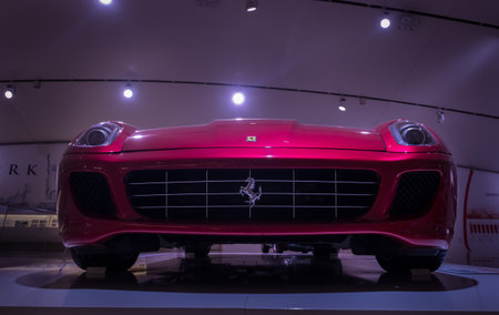Modena, Italy - July 14, 2021: Silver prancing Ferrari horse Logo on the Red Ferrari high-performance Italian sports car radiator grill in Museo Casa Enzo Ferrari, Italy.のeditorial素材